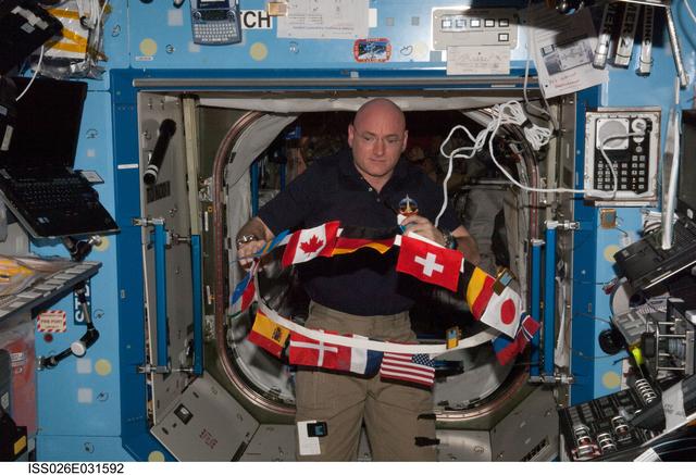 NASA image: Kelly works with flags of the International Partners