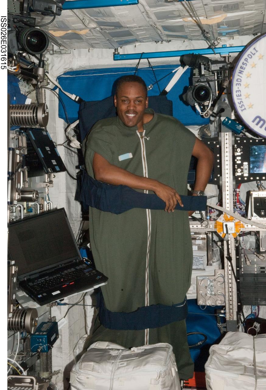 ISS026-E-031615 (3 March 2011) --- NASA astronaut Alvin Drew, STS-133 mission specialist, is pictured in his sleeping bag, which is attached in the Columbus laboratory of the International Space Station while space shuttle Discovery remains docked with the station.