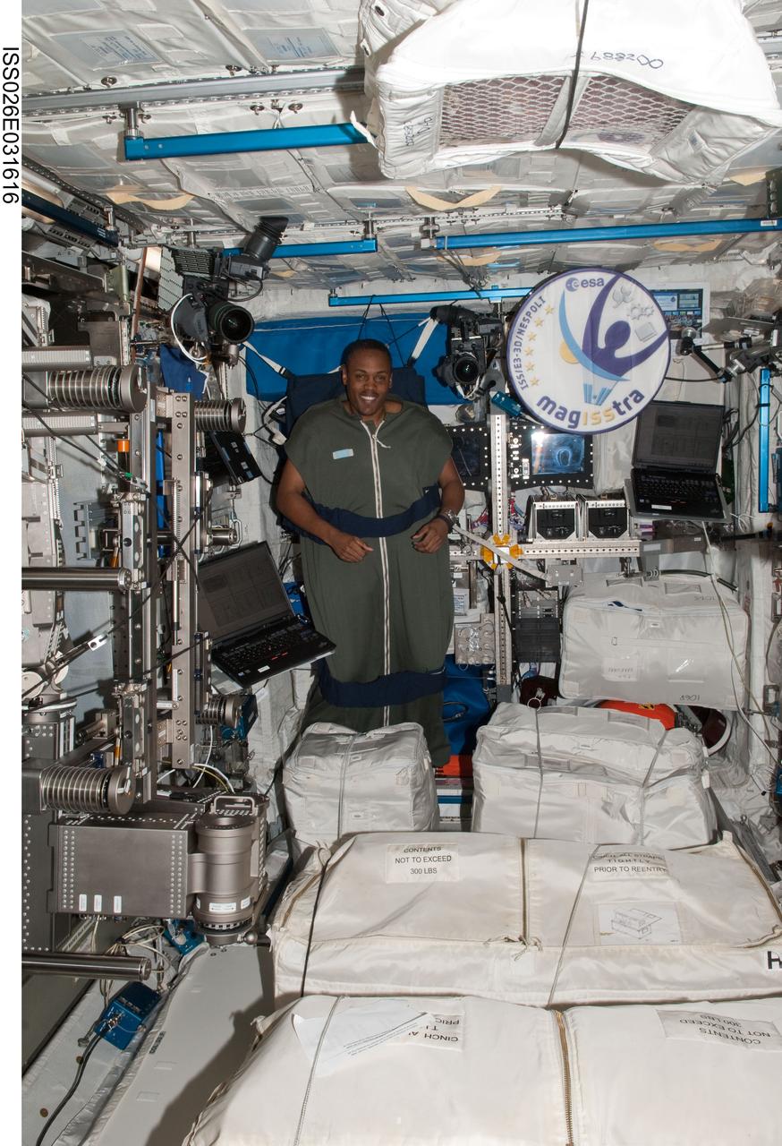 ISS026-E-031616 (3 March 2011) --- NASA astronaut Alvin Drew, STS-133 mission specialist, is pictured in his sleeping bag, which is attached in the Columbus laboratory of the International Space Station while space shuttle Discovery remains docked with the station.