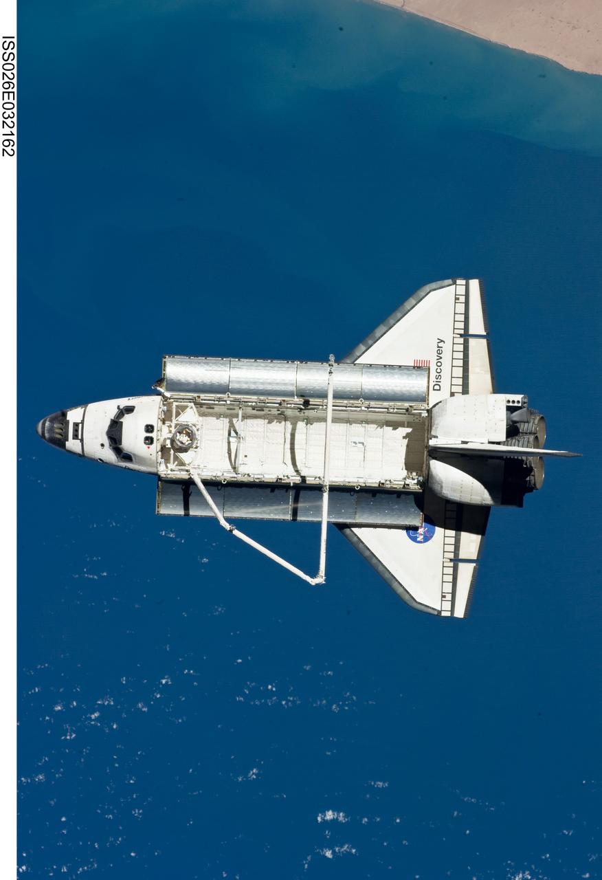ISS026-E-032162 (7 March 2011) --- The space shuttle Discovery is seen from the International Space Station as the two orbital spacecraft accomplish their relative separation on March 7 after an aggregate of 12 astronauts and cosmonauts worked together for over a week. The area below is in the northern Atlantic. During a post undocking fly-around, the crew members aboard the two spacecraft collected a series of photos of each other’s vehicle.