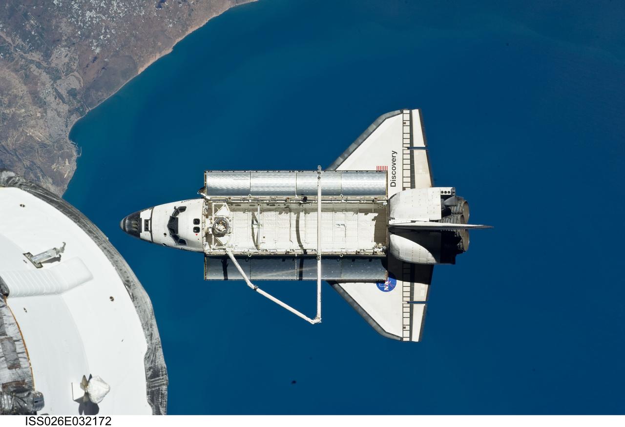 ISS026-E-032172 (7 March 2011) --- The space shuttle Discovery is seen from the International Space Station as the two orbital spacecraft accomplish their relative separation on March 7 after an aggregate of 12 astronauts and cosmonauts worked together for over a week. The area below is the coast of Morocco in the northern Atlantic. During a post undocking fly-around, the crew members aboard the two spacecraft collected a series of photos of each other’s vehicle.