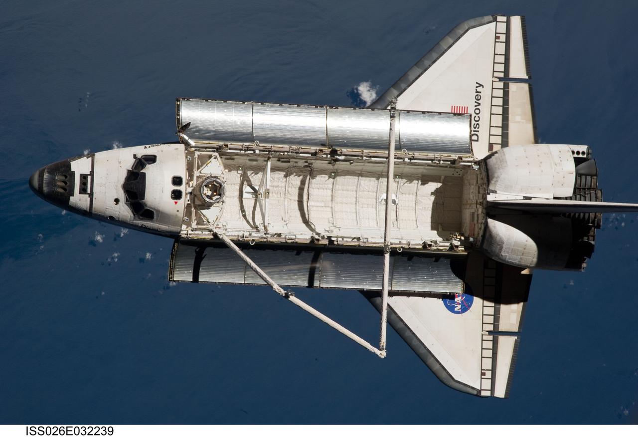 ISS026-E-032239 (7 March 2011) --- The space shuttle Discovery is seen from the International Space Station as the two orbital spacecraft accomplish their relative separation on March 7 after an aggregate of 12 astronauts and cosmonauts worked together for over a week. The blue water below is in the northern Atlantic. During a post undocking fly-around, the crew members aboard the two spacecraft collected a series of photos of each other’s vehicle.