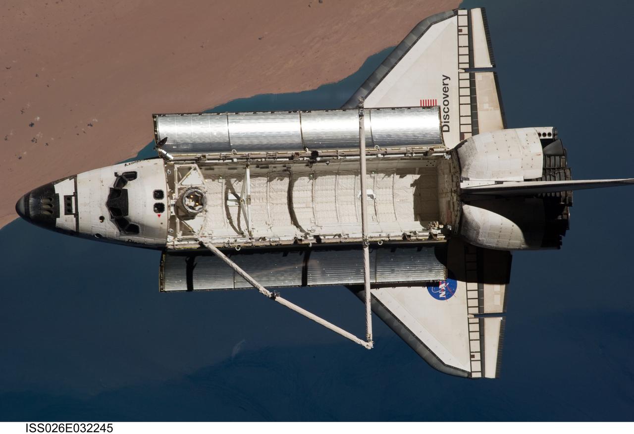 ISS026-E-032245 (7 March 2011) --- The space shuttle Discovery is seen from the International Space Station as the two orbital spacecraft accomplish their relative separation on March 7 after an aggregate of 12 astronauts and cosmonauts worked together for over a week. The area below is the southwestern coast of Morocco in the northern Atlantic. During a post undocking fly-around, the crew members aboard the two spacecraft collected a series of photos of each other’s vehicle.