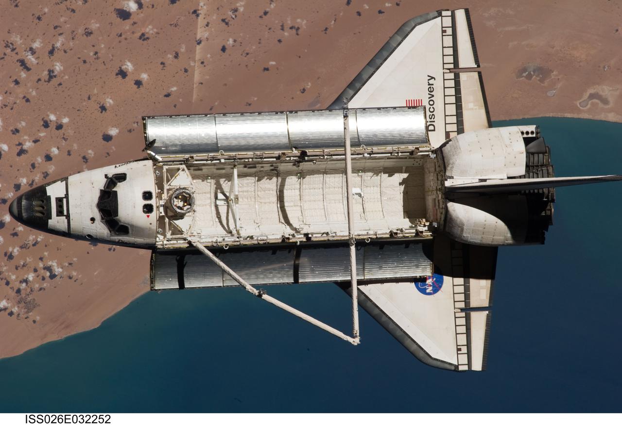 ISS026-E-032252 (7 March 2011) --- The space shuttle Discovery is seen from the International Space Station as the two orbital spacecraft accomplish their relative separation on March 7 after an aggregate of 12 astronauts and cosmonauts worked together for over a week. The area below is the southwestern coast of Morocco in the northern Atlantic. During a post undocking fly-around, the crew members aboard the two spacecraft collected a series of photos of each other’s vehicle.