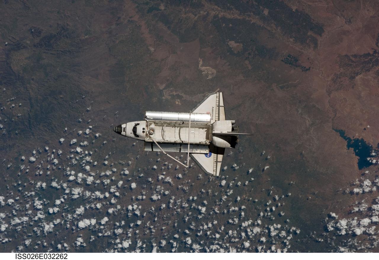 ISS026-E-032262 (7 March 2011) --- The space shuttle Discovery is seen from the International Space Station as the two orbital spacecraft accomplish their relative separation on March 7 after an aggregate of 12 astronauts and cosmonauts worked together for over a week. During a post undocking fly-around, the crew members aboard the two spacecraft collected a series of photos of each other’s vehicle.