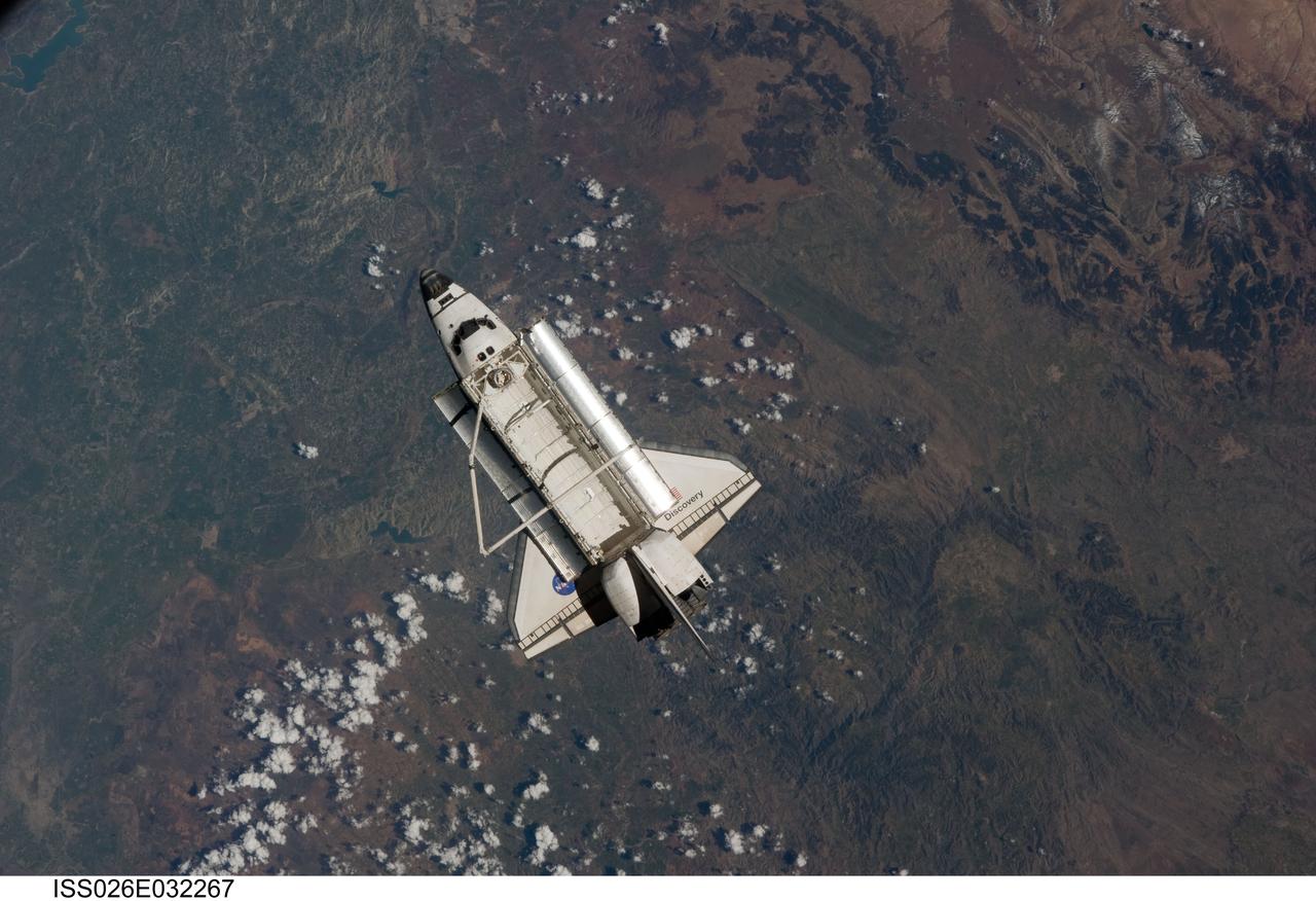 ISS026-E-032267 (7 March 2011) --- The space shuttle Discovery is seen from the International Space Station as the two orbital spacecraft accomplish their relative separation on March 7 after an aggregate of 12 astronauts and cosmonauts worked together for over a week. During a post undocking fly-around, the crew members aboard the two spacecraft collected a series of photos of each other’s vehicle.