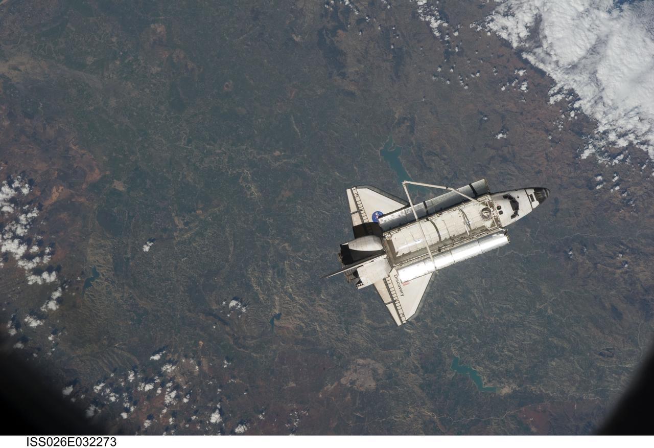 ISS026-E-032273 (7 March 2011) --- The space shuttle Discovery is seen from the International Space Station as the two orbital spacecraft accomplish their relative separation on March 7 after an aggregate of 12 astronauts and cosmonauts worked together for over a week. During a post undocking fly-around, the crew members aboard the two spacecraft collected a series of photos of each other’s vehicle.
