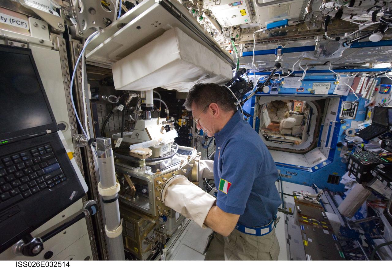 ISS026-E-032514 (8 March 2011) --- European Space Agency astronaut Paolo Nespoli, Expedition 26 flight engineer, works with the Light Microscopy Module (LMM) in the Destiny laboratory of the International Space Station.