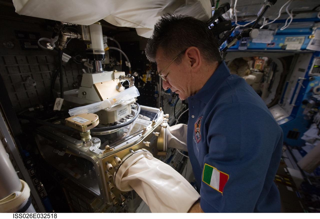 ISS026-E-032518 (8 March 2011) --- European Space Agency astronaut Paolo Nespoli, Expedition 26 flight engineer, works with the Light Microscopy Module (LMM) in the Destiny laboratory of the International Space Station.