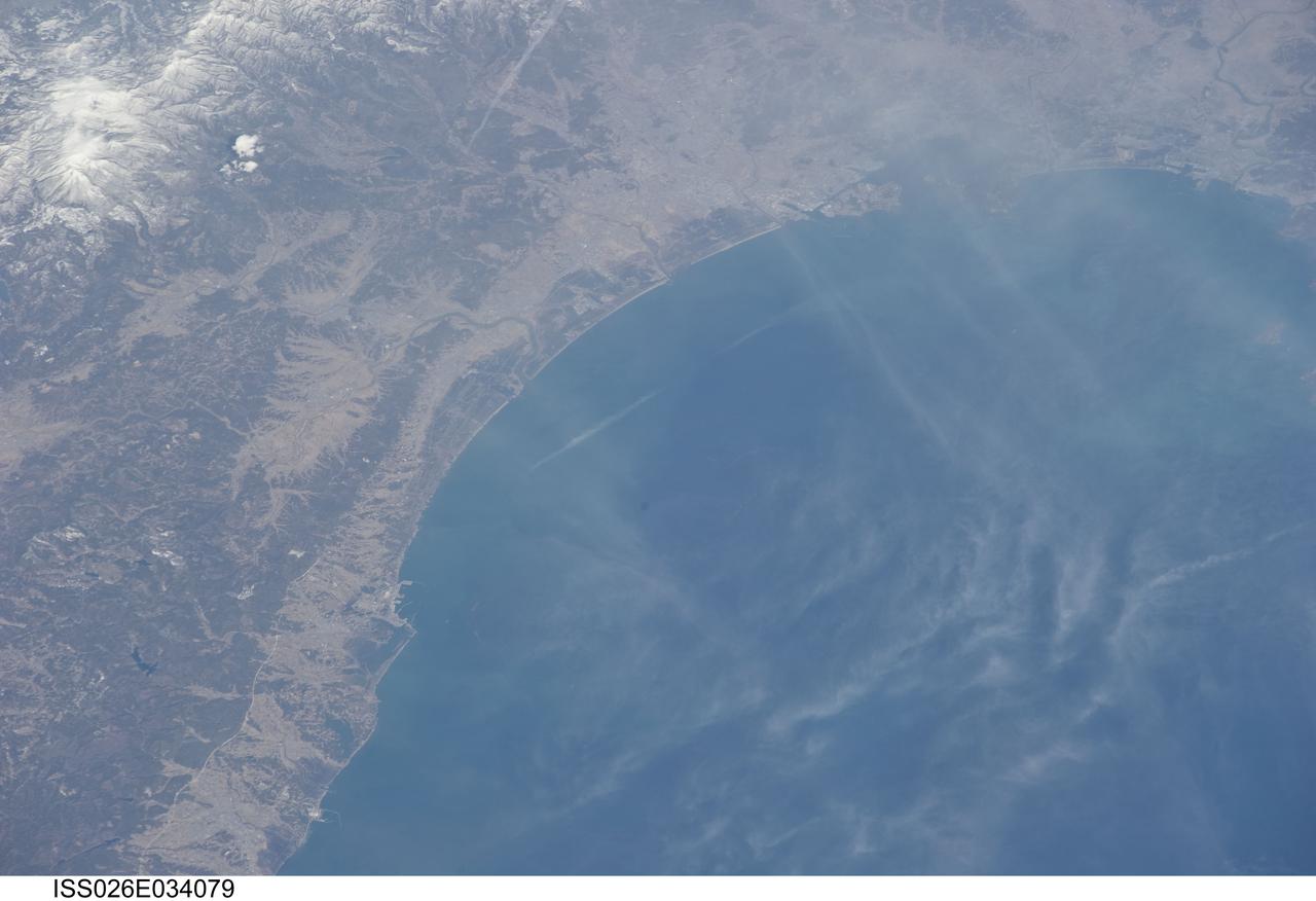 ISS026-E-034079 (14 March 2011) --- From 220 miles above Japan, an Expedition 26 crew member onboard the International Space Station took this 200mm view of the Sendai coast and southward, on March 14, three days after the   one-two-punch of earthquake and tsunami.