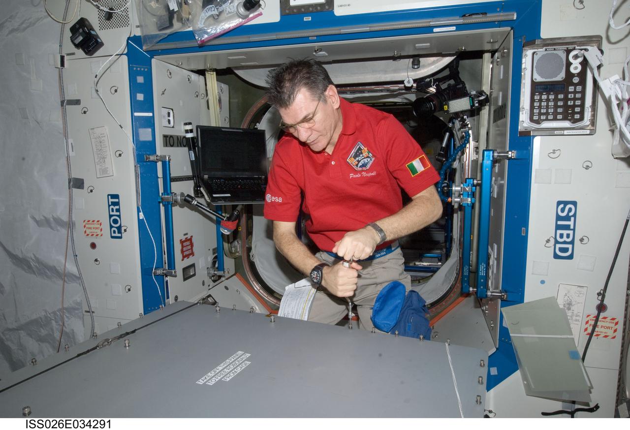 ISS026-E-034291 (15 March 2011) --- European Space Agency astronaut Paolo Nespoli, Expedition 26/27 flight engineer, opens the container that holds Robonaut 2, the dexterous humanoid astronaut helper, in the Destiny laboratory of the International Space Station.