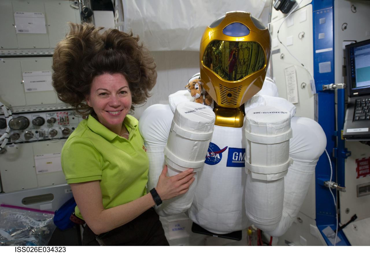 ISS026-E-034323 (15 March 2011) --- NASA astronaut Cady Coleman, Expedition 26/27 flight engineer, poses with Robonaut 2, the dexterous humanoid astronaut helper, in the Destiny laboratory of the International Space Station.