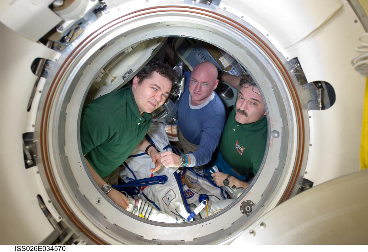 ISS026-E-034570 (16 March 2011) --- NASA astronaut Scott Kelly (center), Expedition 26 commander; along with Russian cosmonauts Oleg Skripochka (left) and Alexander Kaleri, both flight engineers, are pictured in the Soyuz TMA-01M spacecraft prior to their departure from the International Space Station on March 16, 2011.