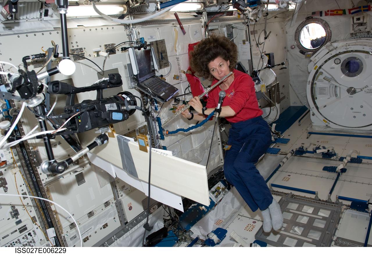 ISS027-E-006229 (19 March 2011) --- During some free time, NASA astronaut Cady Coleman, Expedition 27 flight engineer,  plays a flute in the JAXA Kibo laboratory onboard the International Space Station.