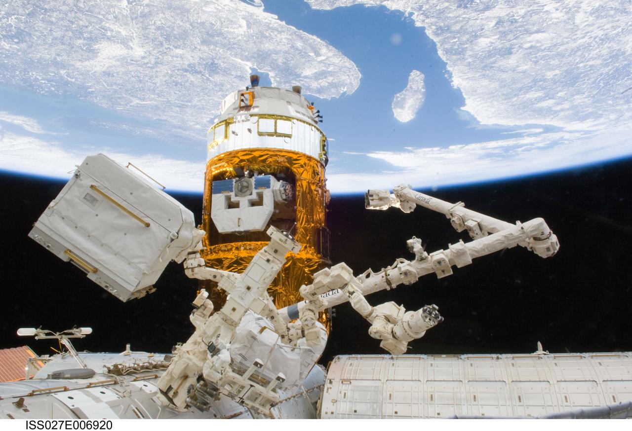 ISS027-E-006920 (20 March 2011) --- The docked Kounotori2 H-II Transfer Vehicle (HTV-2), Canadarm2; and Canadian-built Dextre, also known as the Special Purpose Dextrous Manipulator (SPDM), are pictured as photographed by an Expedition 27 crew member, using a camera equipped with a 17mm lens, aboard the International Space Station. The scene on Earth, some 220 miles below, includes the Gulf of St. Lawrence leading to the St. Lawrence Seaway. North is toward the upper right corner. The large Island in the upper right quadrant is Anticosti Island. Nova Scotia, Bay of Fundy, New Brunswick and northern Maine are partially seen to the left side of the image and Quebec and Newfoundland and Labrador are shown on the right of the image