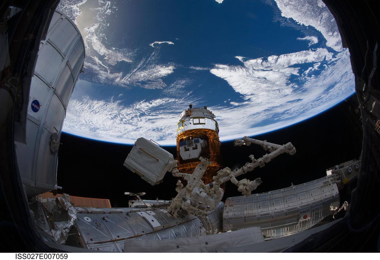 ISS027-E-007059 (20 March 2011) --- An Expedition 27 crew member used a fish-eye lens attached to an electronic still camera to capture this image of a portion of the International Space Station including the docked Kounotori2 H-II Transfer Vehicle (HTV-2); Canadarm2; and Canadian-built Dextre, also known as the Special Purpose Dextrous Manipulator (SPDM). A blue and white part of Earth and the blackness of space provide the backdrop for the scene.