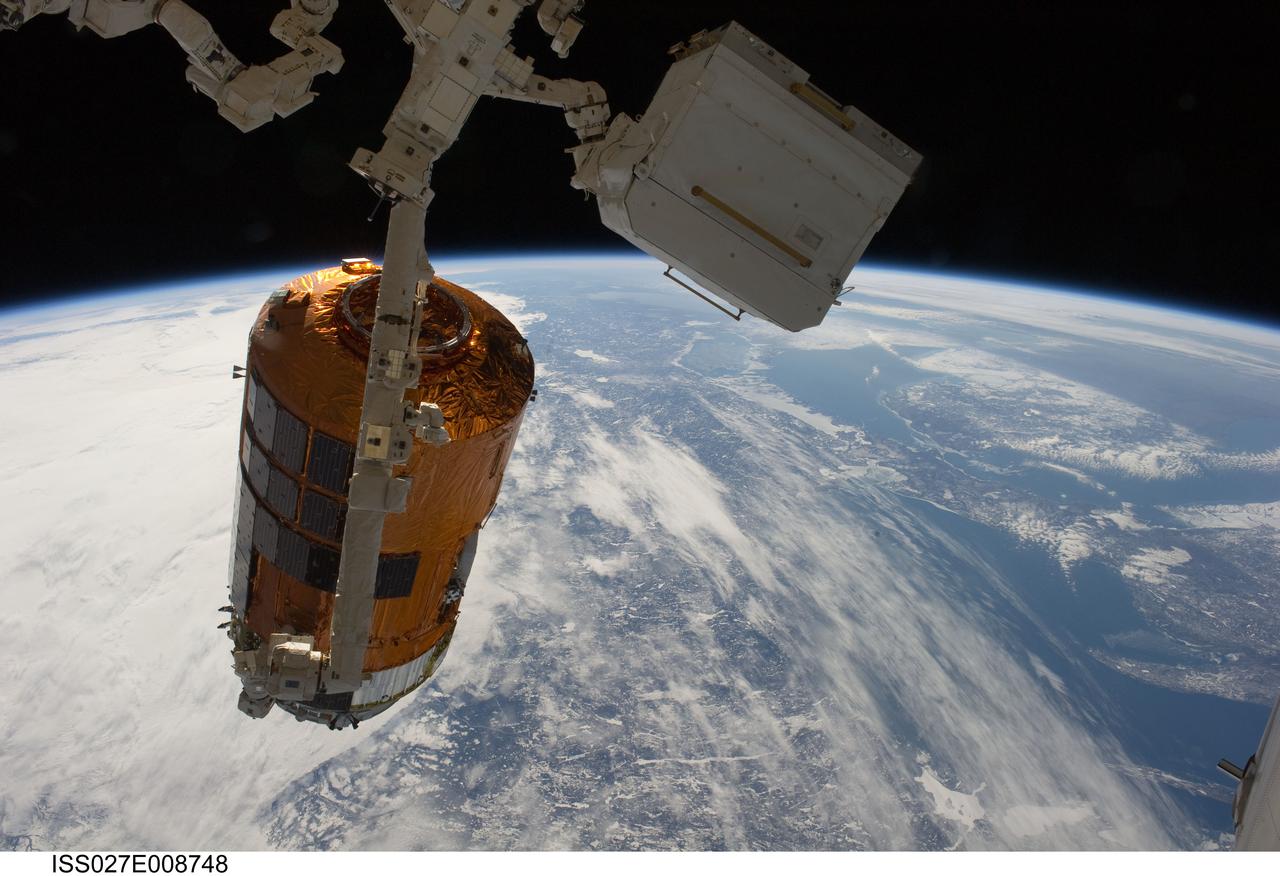 ISS027-E-008748 (28 March 2011) --- Backdropped by Earth?s horizon and the blackness of space, the International Space Station's Canadarm2 unberths the unpiloted Japan Aerospace Exploration Agency?s Kounotori2 H-II Transfer Vehicle (HTV2), filled with trash and unneeded items, in preparation for its release from the station. NASA astronaut Cady Coleman and European Space Agency astronaut Paolo Nespoli, both Expedition 27 flight engineers, used the station?s robot arm to grapple the HTV2 and unberth it from the Earth-facing port of the Harmony node. The cargo craft was released at 11:46 a.m. (EDT) on March 28, 2011.