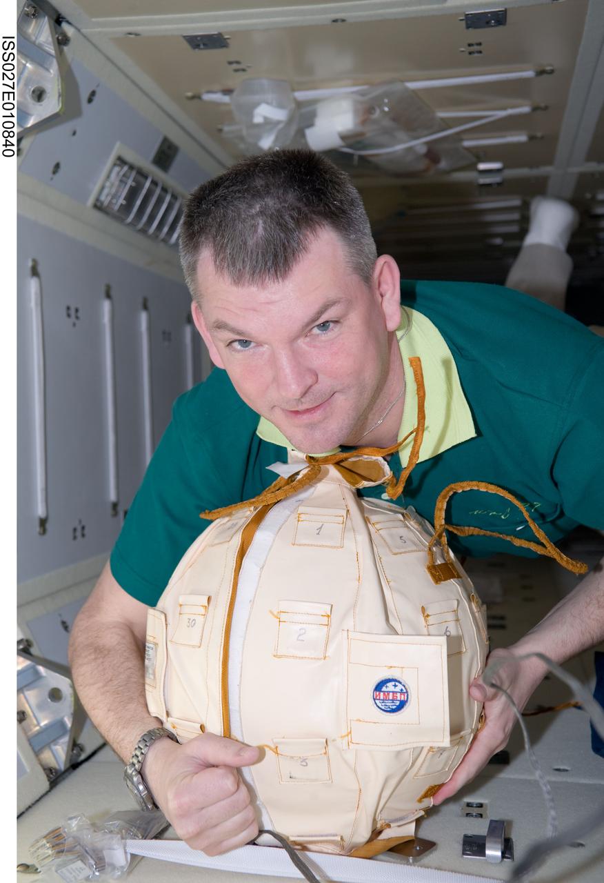 ISS027-E-010840 (8 April 2011) --- Russian cosmonaut Alexander Samokutyaev, Expedition 27 flight engineer, works with Matryoshka-R Phantom hardware in the Rassvet Mini-Research Module 1 (MRM1) of the International Space Station.