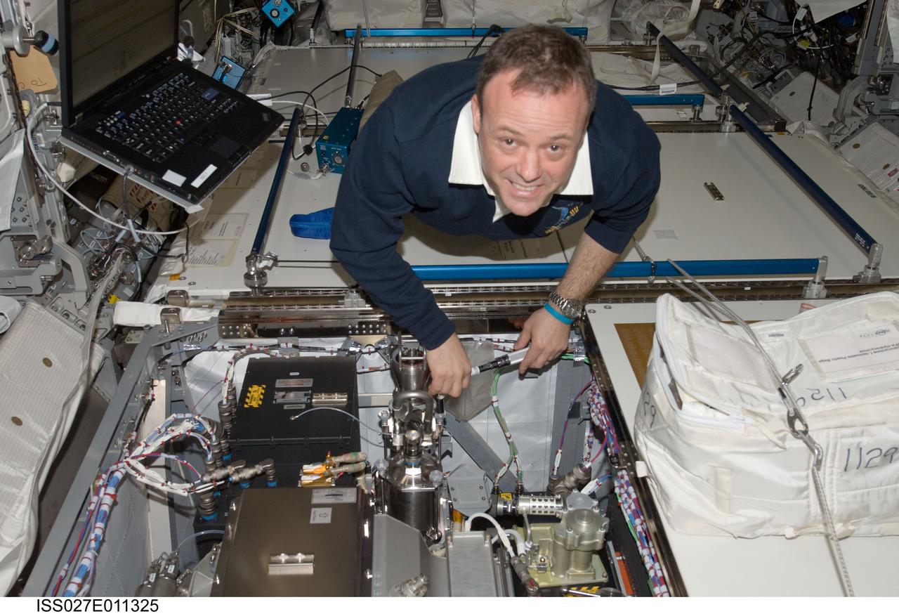 ISS027-E-011325 (8 April 2011) --- NASA astronaut Ron Garan, Expedition 27 flight engineer, works on degassing the water loop of the running Water Pump Assembly 2 / Thermal Control System (WPA2/TCS) in the Columbus laboratory of the International Space Station.