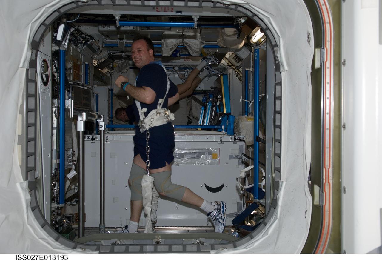 ISS027-E-013193 (15 April  2011) --- NASA astronaut Ron Garan, Expedition 27 flight engineer, equipped with a bungee harness, exercises on the Combined Operational Load Bearing External Resistance Treadmill (COLBERT) in the Tranquility node of the International Space Station.