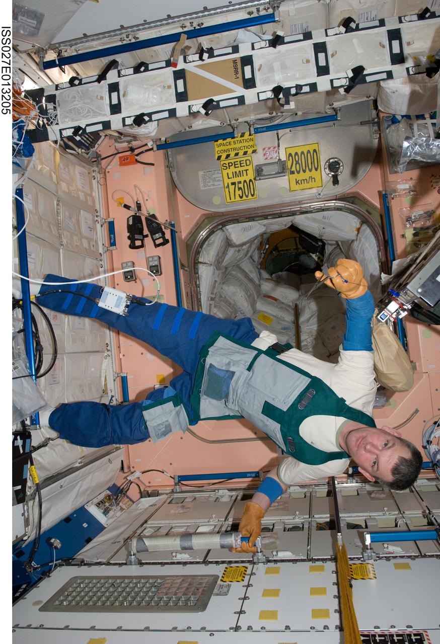 ISS027-E-013205 (15 April 2011) --- Russian cosmonaut Alexander Samokutyaev, Expedition 27 flight engineer, wearing in a work apron, is pictured in the Unity node of the International Space Station.