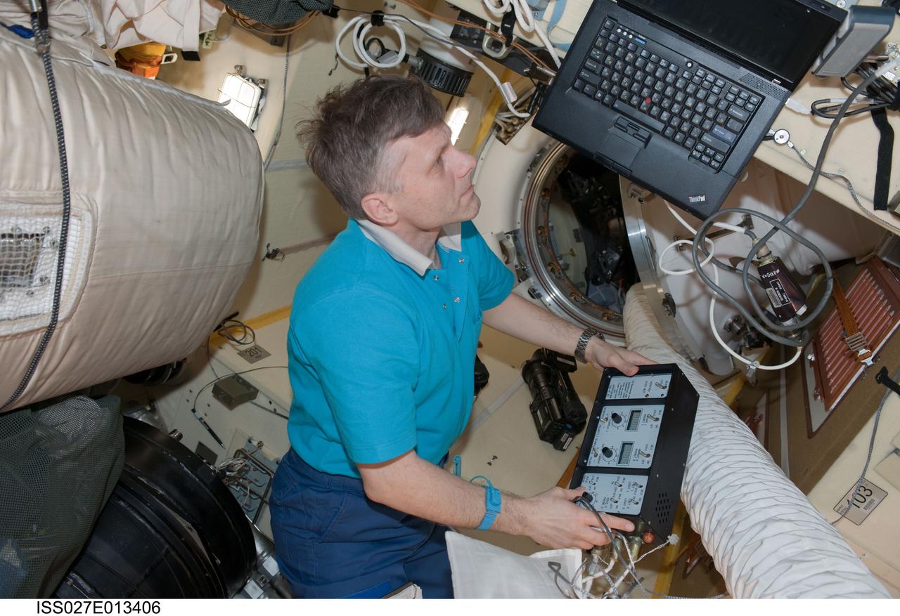 ISS027-E-013406 (18 April 2011) --- Russian cosmonaut Andrey Borisenko, Expedition 27 flight engineer, conducts an active session for the Russian experiment KPT-10 "Kulonovskiy Kristall" (Coulomb Crystal) in the Poisk Mini-Research Module 2 (MRM2) of the International Space Station.