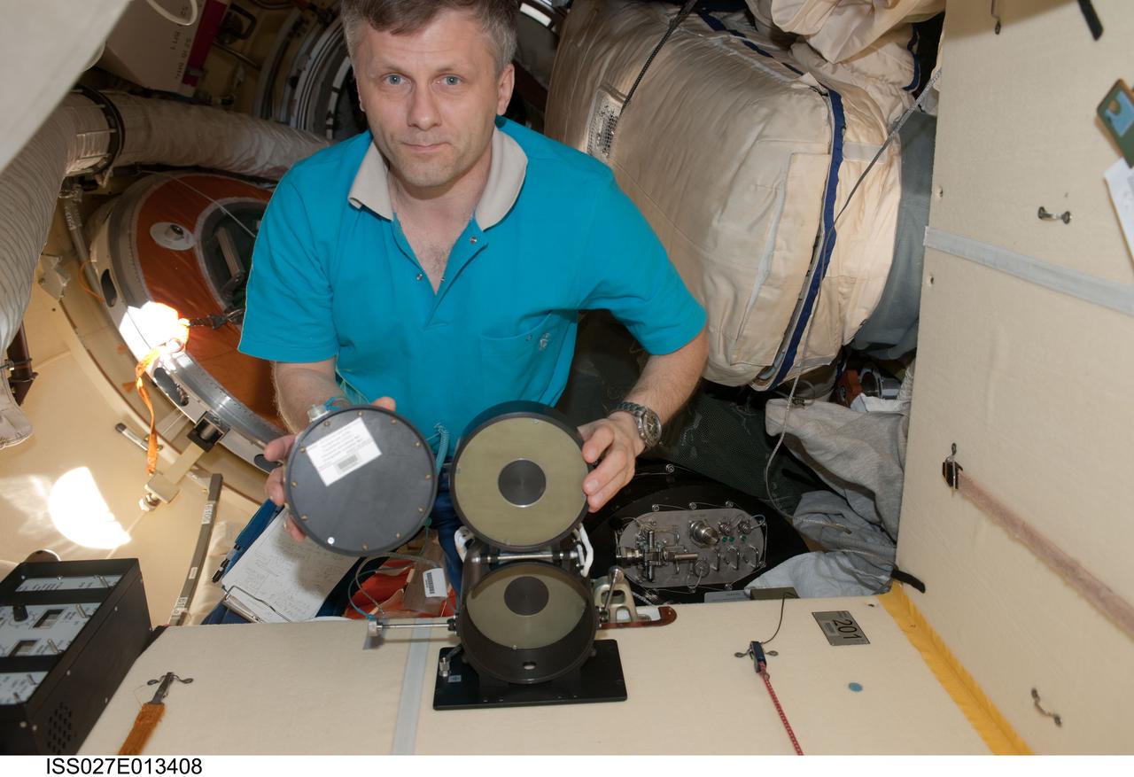 ISS027-E-013408 (18 April 2011) --- Russian cosmonaut Andrey Borisenko, Expedition 27 flight engineer, conducts an active session for the Russian experiment KPT-10 "Kulonovskiy Kristall" (Coulomb Crystal) in the Poisk Mini-Research Module 2 (MRM2) of the International Space Station.