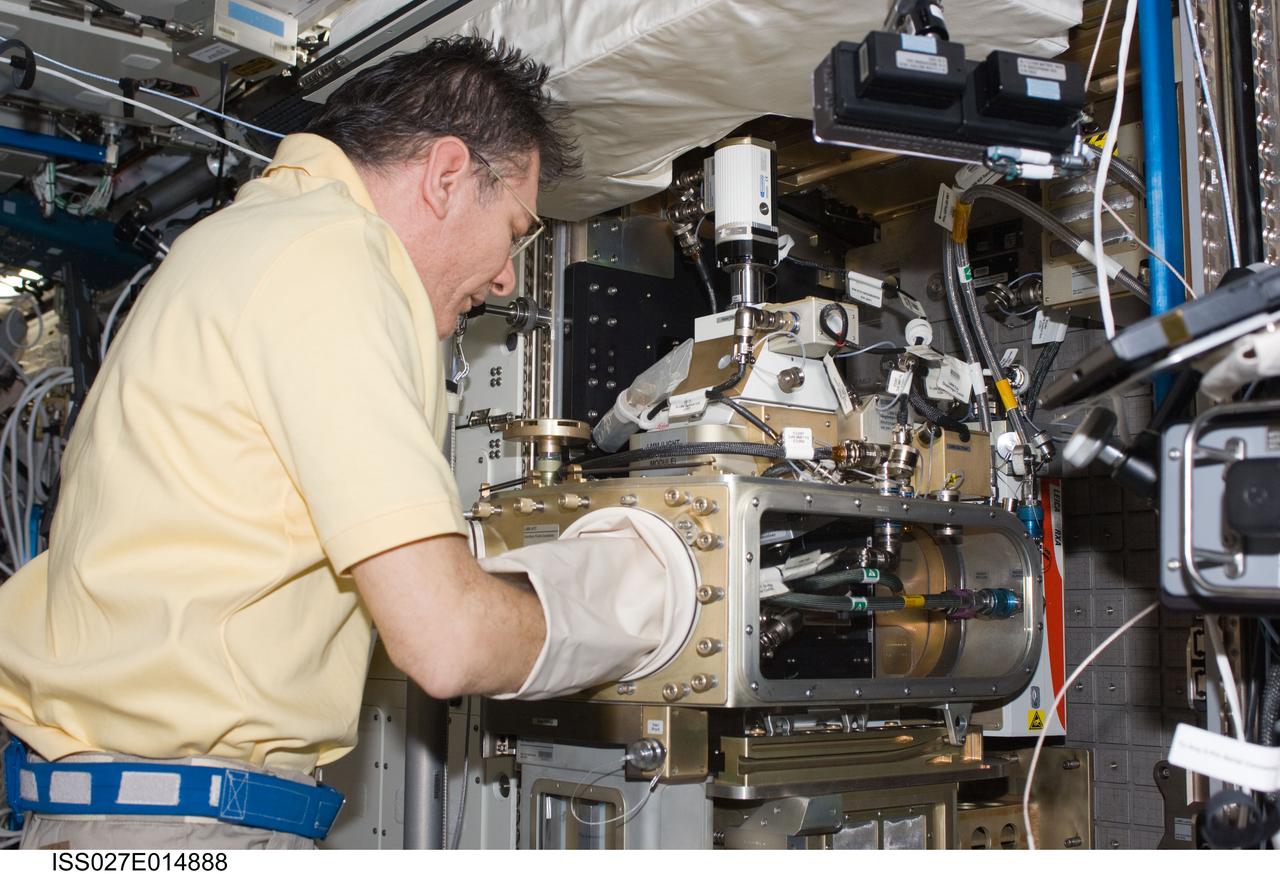 ISS027-E-014888 (21 April 2011) --- European Space Agency astronaut Paolo Nespoli, Expedition 27 flight engineer, works with the Light Microscopy Module (LMM) in the Destiny laboratory of the International Space Station.