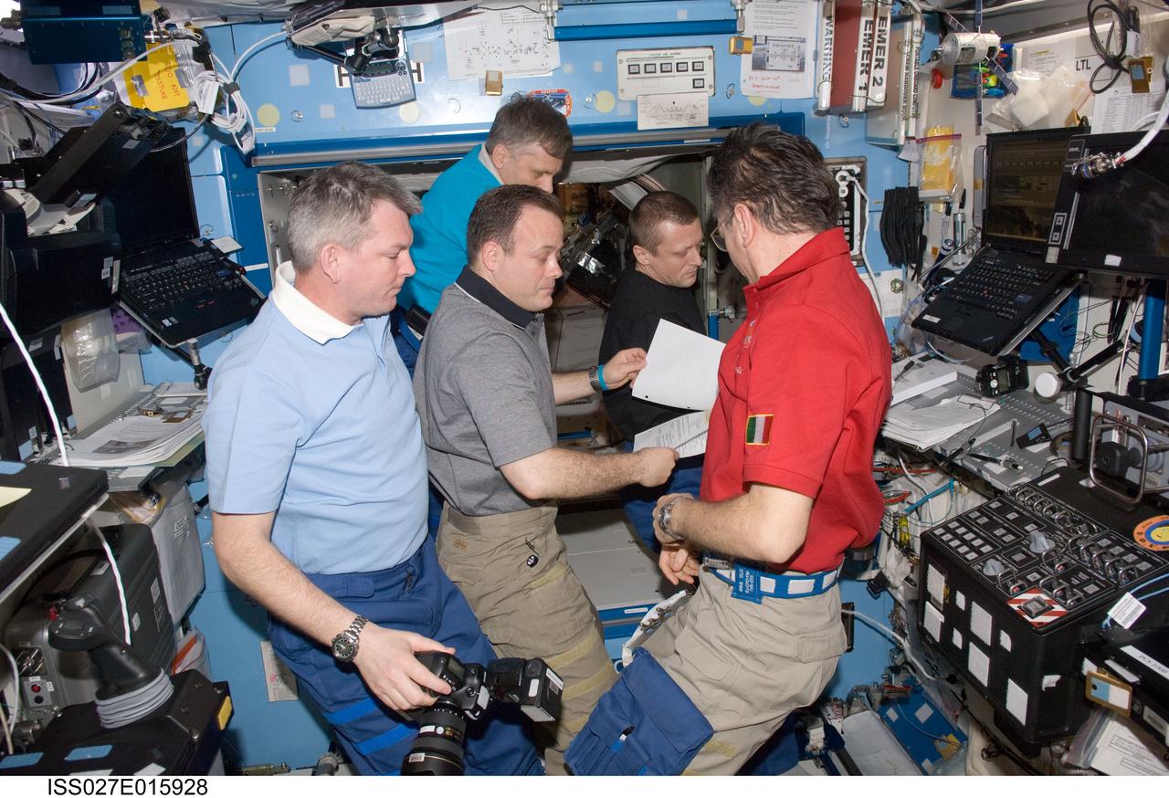 ISS027-E-015928 (19 April 2011) --- Expedition 27 crew members discuss mission activities in the Destiny laboratory of the International Space Station. Pictured clockwise from the left are Russian cosmonaut Alexander Samokutyaev, NASA astronaut Ron Garan, Russian cosmonaut Andrey Borisenko, all flight engineers; Russian cosmonaut Dmitry Kondratyev, commander; and European Space Agency astronaut Paolo Nespoli, flight engineer.