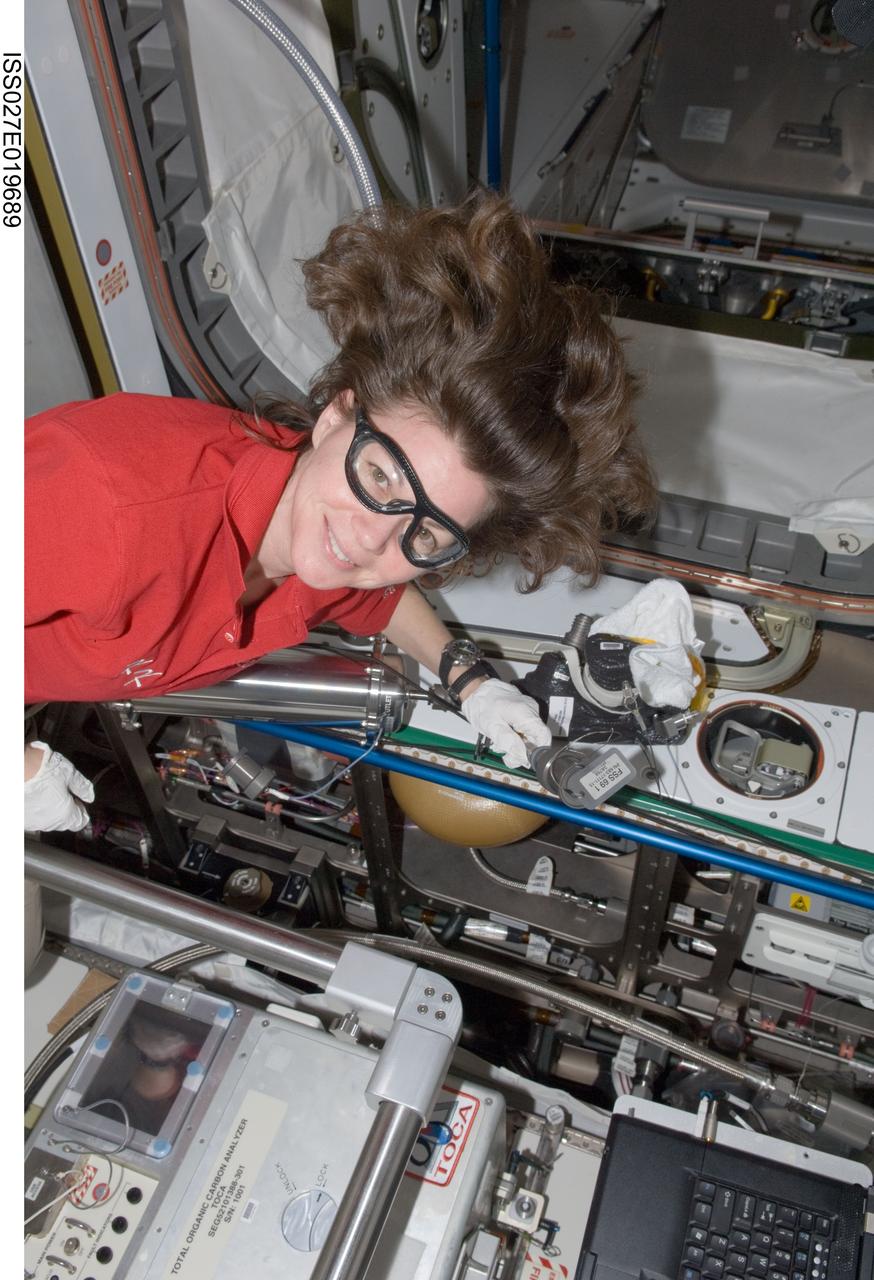 ISS027-E-019689 (22 April 2011) --- NASA astronaut Cady Coleman, Expedition 27 flight engineer, works with the Internal Thermal Control System Moderate Temperature Loop (ITCS MTL) in the Tranquility node of the International Space Station.