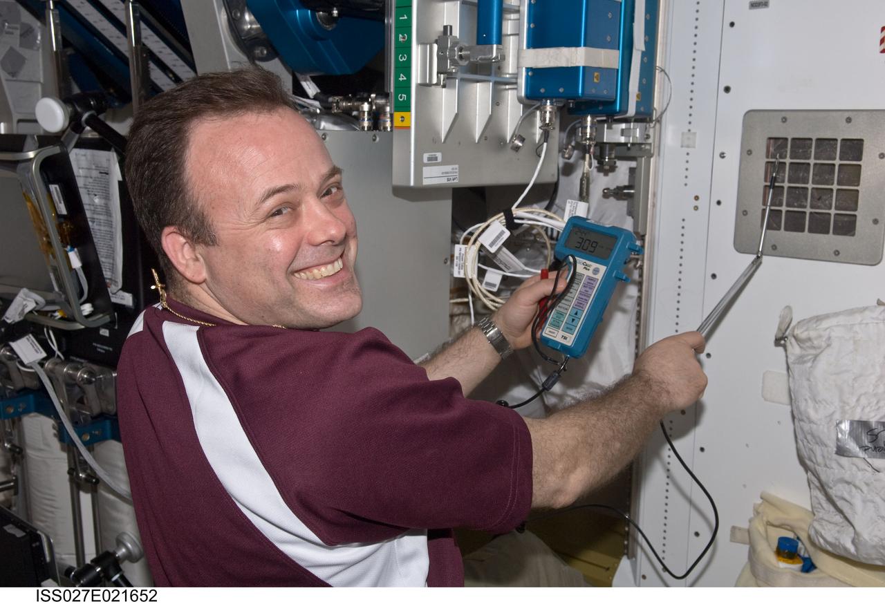 ISS027-E-021652 (4 May 2011) --- NASA astronaut Ron Garan, Expedition 27 flight engineer, uses a portable ventilation test instrument to take intermodular ventilation (IMV) flow measurements in Tranquility (Node 3) aboard the International Space Station.
