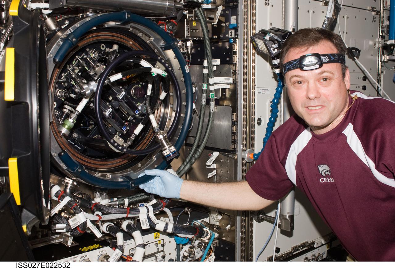 ISS027-E-022532 (5 May 2011) --- NASA astronaut Ron Garan, Expedition 27 flight engineer, services the Combustion Integrated Rack (CIR) Multi-user Drop Combustion Apparatus (MDCA) in the Destiny laboratory of the International Space Station.
