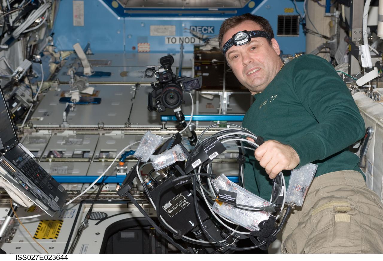 ISS027-E-023644 (6 May 2011) --- NASA astronaut Ron Garan, Expedition 27 flight engineer, works with ISS Agricultural Camera (ISSAC) hardware in the Destiny laboratory of the International Space Station. ISSAC, a successor of the earlier AgCam, will operate in conjunction with EarthKAM, both instruments to conduct simultaneous but independent operations in the WORF rack in Destiny.