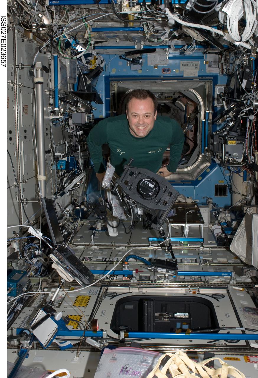 ISS027-E-023657 (6 May 2011) --- NASA astronaut Ron Garan, Expedition 27 flight engineer, works with ISS Agricultural Camera (ISSAC) hardware in the Destiny laboratory of the International Space Station. ISSAC, a successor of the earlier AgCam, will operate in conjunction with EarthKAM, both instruments to conduct simultaneous but independent operations in the WORF rack in Destiny.