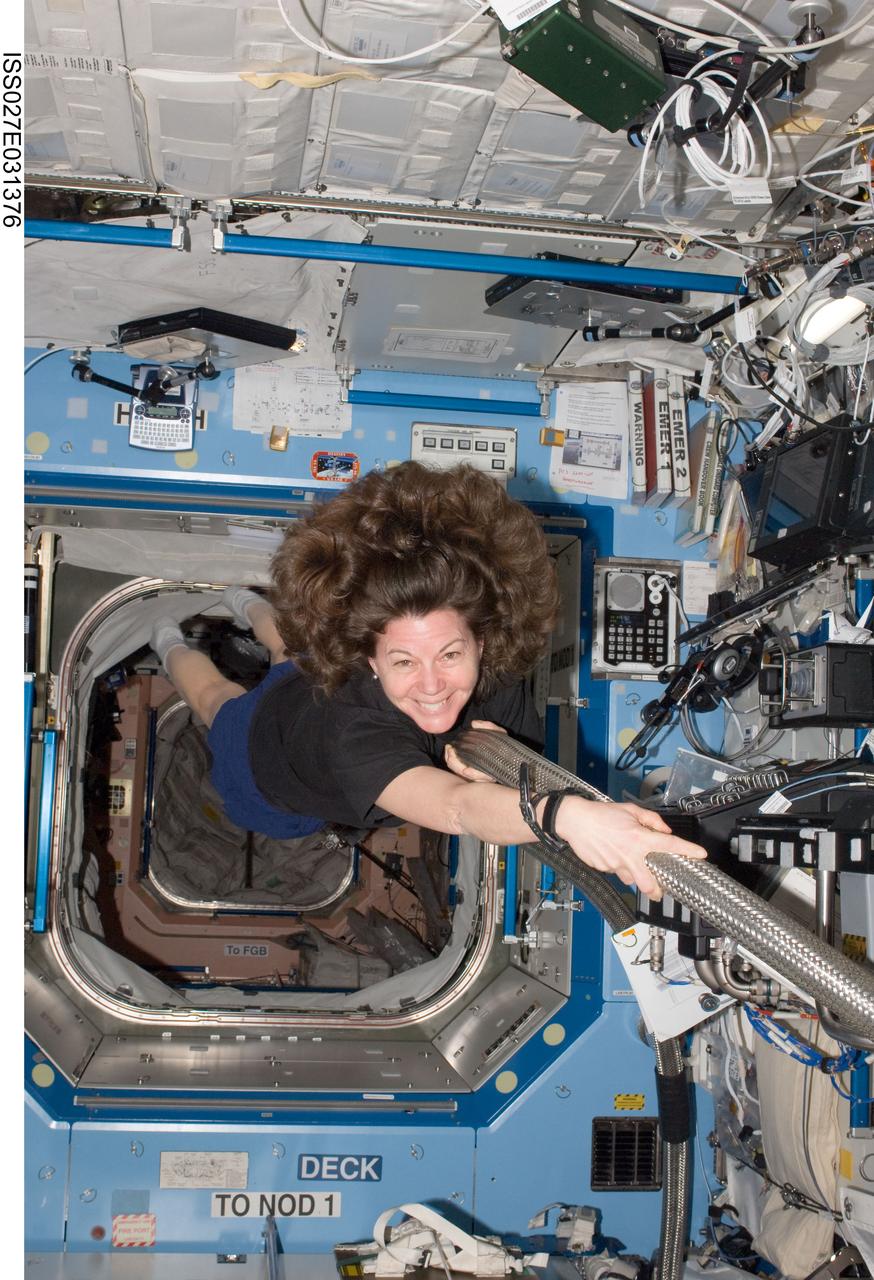 ISS027-E-031376 (14 May 2011) --- NASA astronaut Cady Coleman, Expedition 27 flight engineer, works with the Major Constituent Analyzer / Data & Control Assembly (MCA DCA) in the Destiny laboratory of the International Space Station.