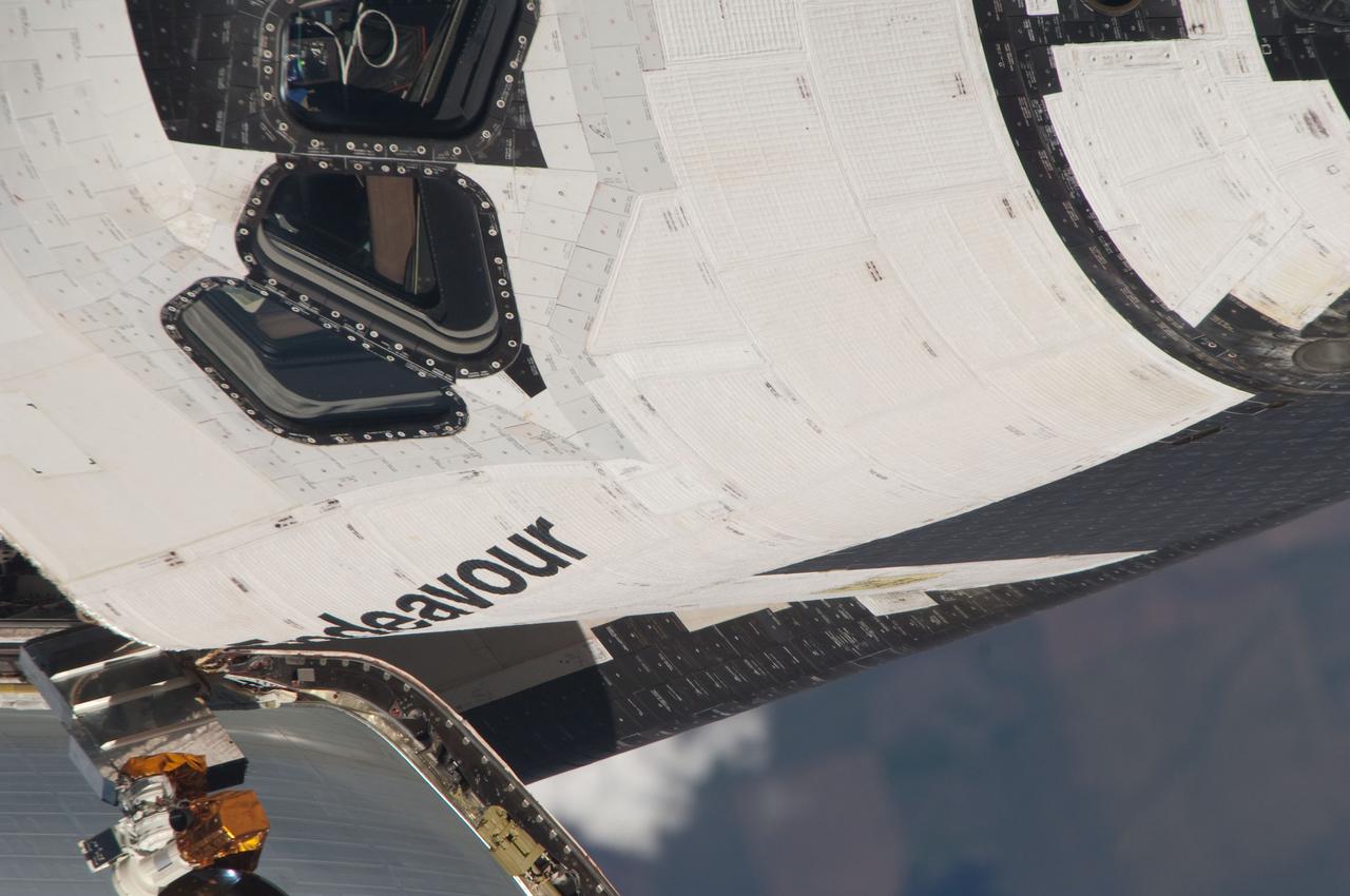 ISS027-E-032126 (18 May 2011) --- This close-up view of the starboard side of space shuttle Endeavour’s crew cabin was provided by an Expedition 27 crew member during a survey of the approaching STS-134 vehicle prior to docking with the International Space Station. As part of the survey and part of every mission's activities, Endeavour performed a back-flip for the rendezvous pitch maneuver (RPM). The station crew member used a digital still camera with an 800mm focal length, as the two spacecraft were approximately 600 feet (180 meters) apart.