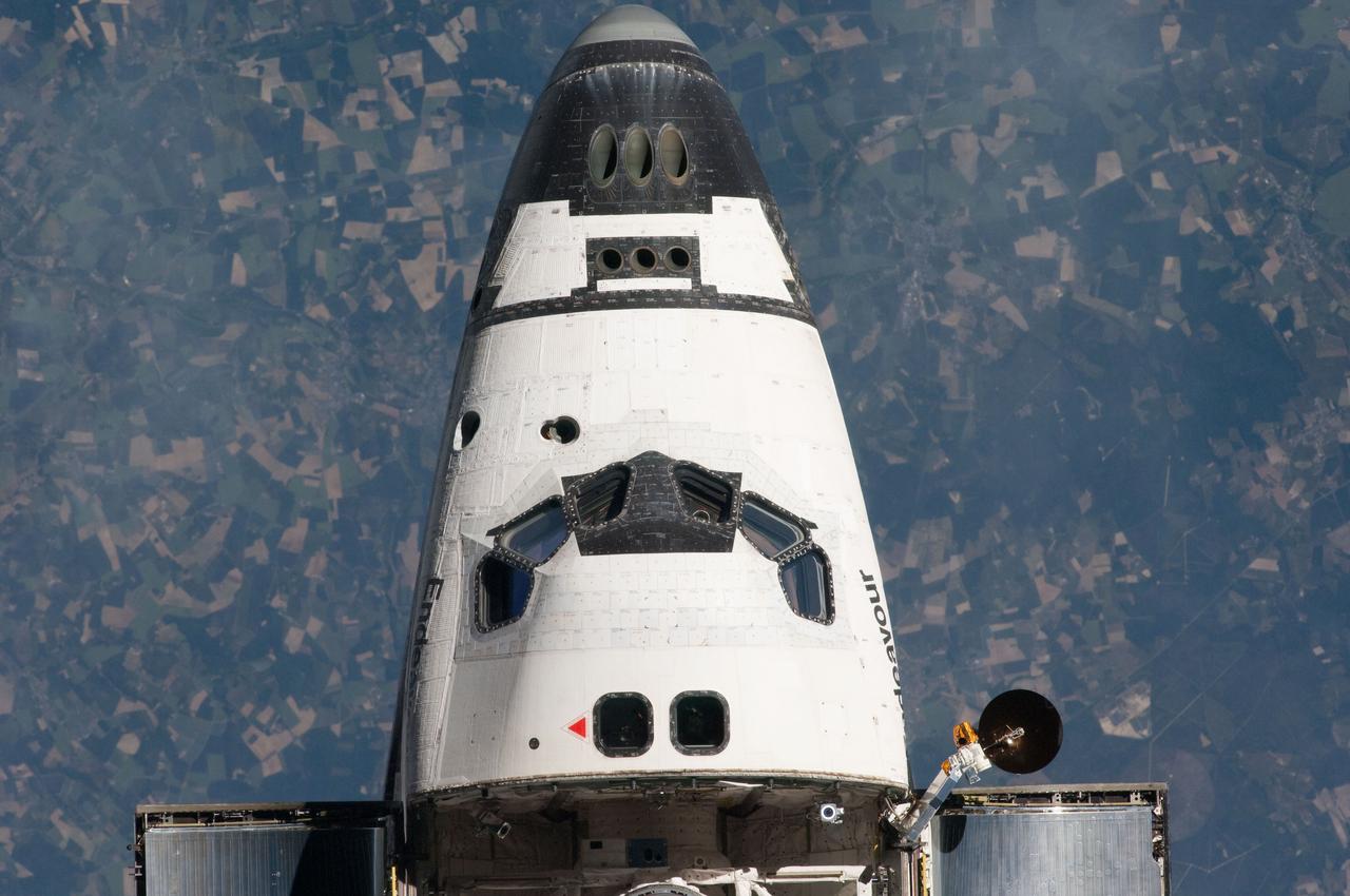 ISS027-E-032215 (18 May 2011) --- This view of the nose and crew cabin of the space shuttle Endeavour was provided by an Expedition 27 crew member during a survey of the approaching STS-134 vehicle prior to docking with the International Space Station. As part of the survey and part of every mission's activities, Endeavour performed a back-flip for the rendezvous pitch maneuver (RPM). The image was photographed with a digital still camera, using a 400mm lens at a distance of about 600 feet (180 meters).