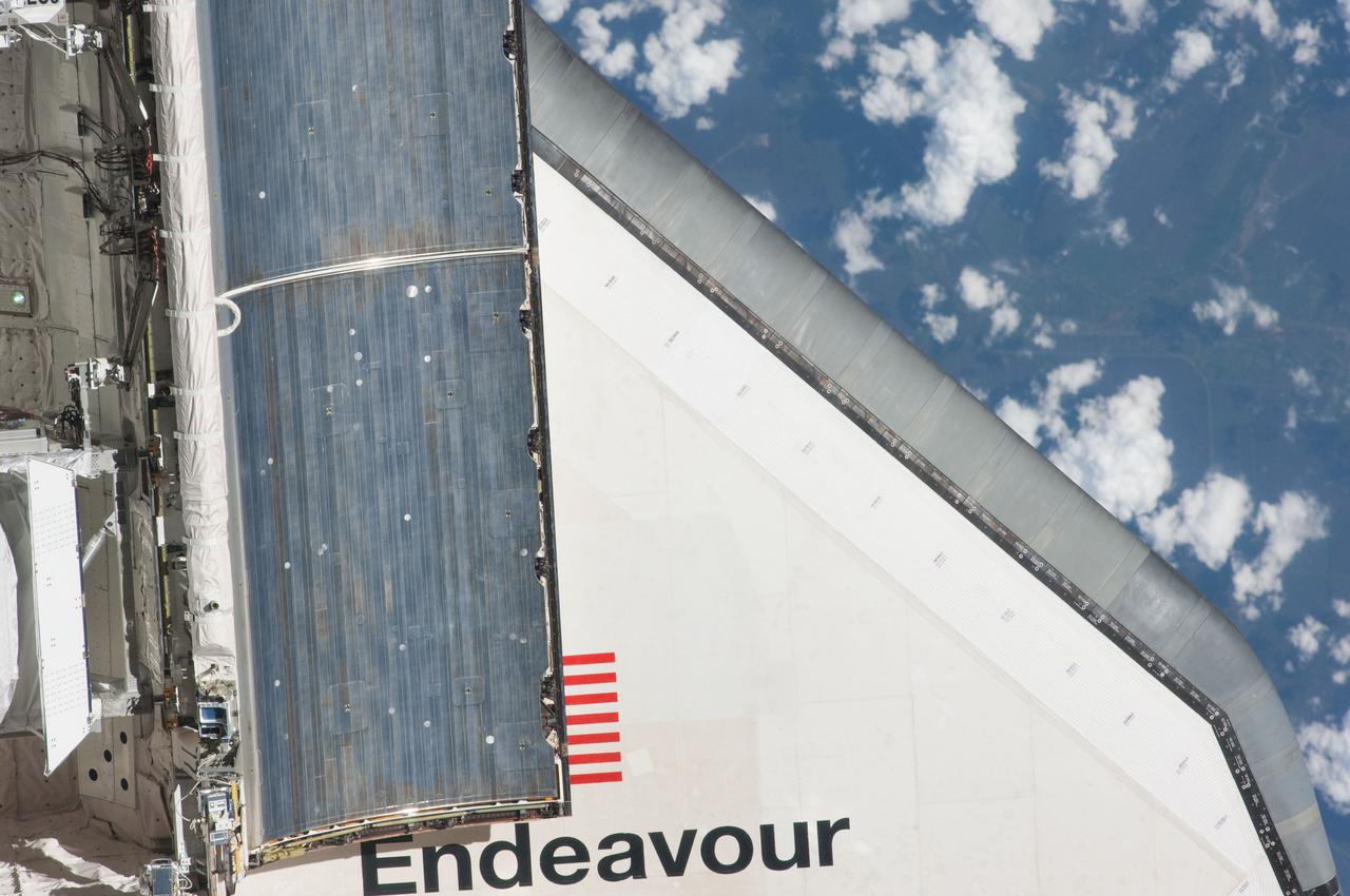 ISS027-E-032227 (18 May 2011) --- This partial view of the starboard wing of the space shuttle Endeavour was provided by an Expedition 27 crew member during a survey of the approaching STS-134 vehicle prior to docking with the International Space Station. As part of the survey and part of every mission's activities, Endeavour performed a back-flip for the rendezvous pitch maneuver (RPM). The image was photographed with a digital still camera, using a 400mm lens at a distance of about 600 feet (180 meters).