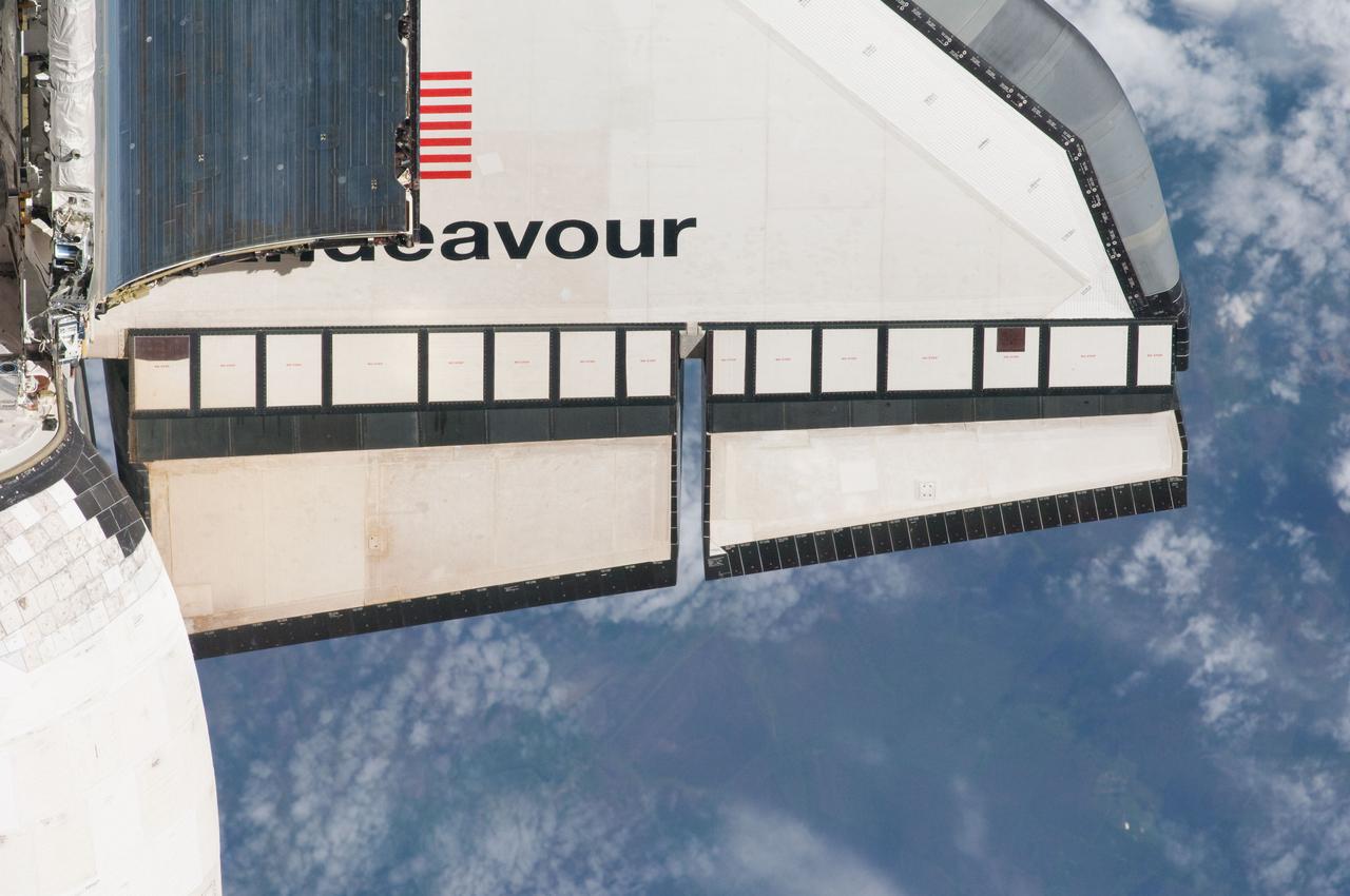 ISS027-E-032234 (18 May 2011) --- This partial view of the starboard wing of the space shuttle Endeavour was provided by an Expedition 27 crew member during a survey of the approaching STS-134 vehicle prior to docking with the International Space Station. As part of the survey and part of every mission's activities, Endeavour performed a back-flip for the rendezvous pitch maneuver (RPM). The image was photographed with a digital still camera, using a 400mm lens at a distance of about 600 feet (180 meters).