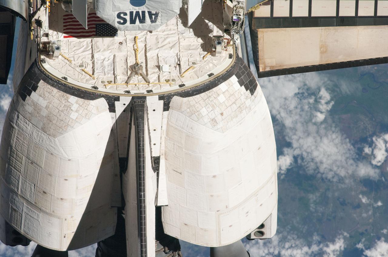 ISS027-E-032241 (18 May 2011) --- This view of the aft portion of the space shuttle Endeavour, including the orbital maneuvering system (OMS) pods and the Alpha Magnetic Spectrometer-2 (AMS) in the payload bay, was provided by an Expedition 27 crew member during a survey of the approaching STS-134 vehicle prior to docking with the International Space Station. As part of the survey and part of every mission's activities, Endeavour performed a back-flip for the rendezvous pitch maneuver (RPM). The image was photographed with a digital still camera, using a 400mm lens at a distance of about 600 feet (180 meters).