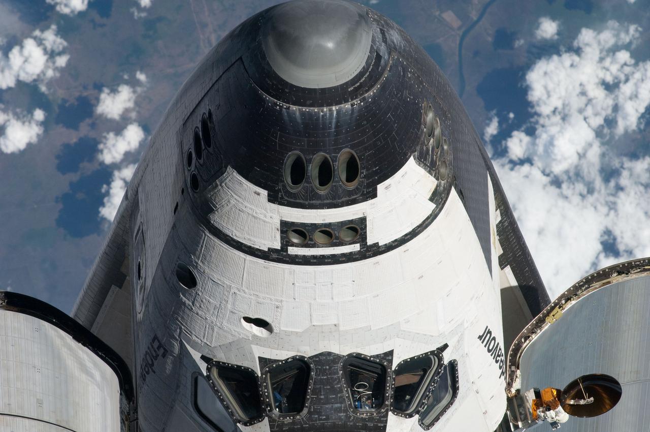 ISS027-E-032247 (18 May 2011) --- This view of the nose and partial crew cabin of the space shuttle Endeavour was provided by an Expedition 27 crew member during a survey of the approaching STS-134 vehicle prior to docking with the International Space Station. As part of the survey and part of every mission's activities, Endeavour performed a back-flip for the rendezvous pitch maneuver (RPM). The image was photographed with a digital still camera, using a 400mm lens at a distance of about 600 feet (180 meters).