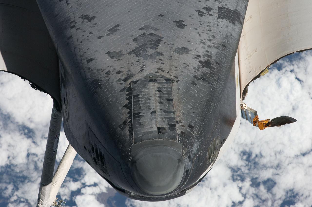 ISS027-E-032274 (18 May 2011) --- This view of the nose and the forward underside of the space shuttle Endeavour was provided by an Expedition 27 crew member during a survey of the approaching STS-134 vehicle prior to docking with the International Space Station. As part of the survey and part of every mission's activities, Endeavour performed a back-flip for the rendezvous pitch maneuver (RPM). The image was photographed with a digital still camera, using a 400mm lens at a distance of about 600 feet (180 meters).