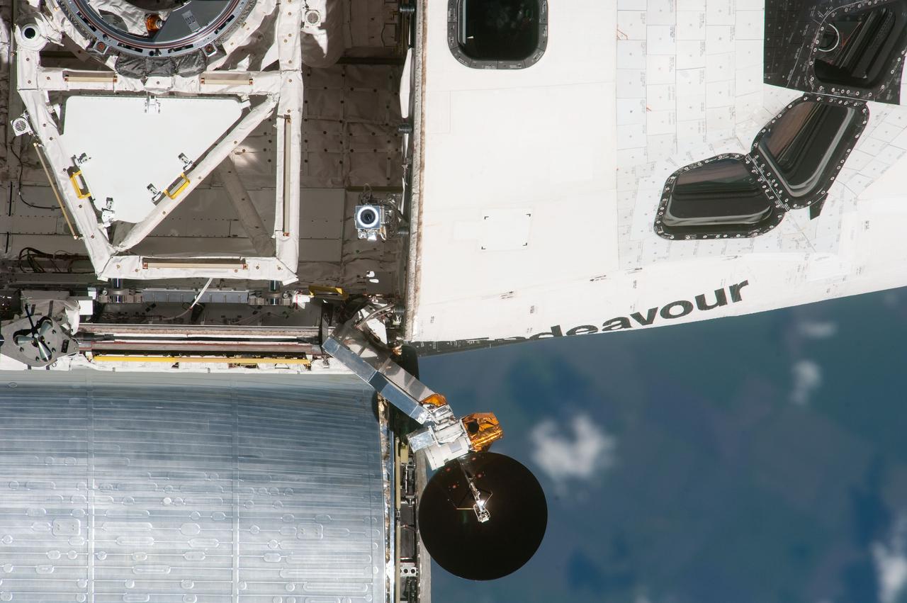 ISS027-E-032285 (18 May 2011) --- This high angle, partial view of the starboard side of the space shuttle Endeavour’s crew cabin and forward payload bay was provided by an Expedition 27 crew member during a survey of the approaching STS-134 vehicle prior to docking with the International Space Station. As part of the survey and part of every mission's activities, Endeavour performed a back-flip for the rendezvous pitch maneuver (RPM). The image was photographed with a digital still camera, using a 1000mm lens.