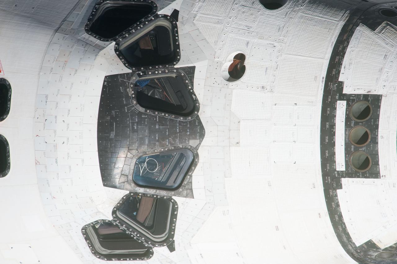 ISS027-E-032429 (18 May 2011) --- This high angle, partial view of the space shuttle Endeavour’s crew cabin was provided by an Expedition 27 crew member during a survey of the approaching STS-134 vehicle prior to docking with the International Space Station. As part of the survey and part of every mission's activities, Endeavour performed a back-flip for the rendezvous pitch maneuver (RPM). The image was photographed with a digital still camera, using a 1000mm lens.