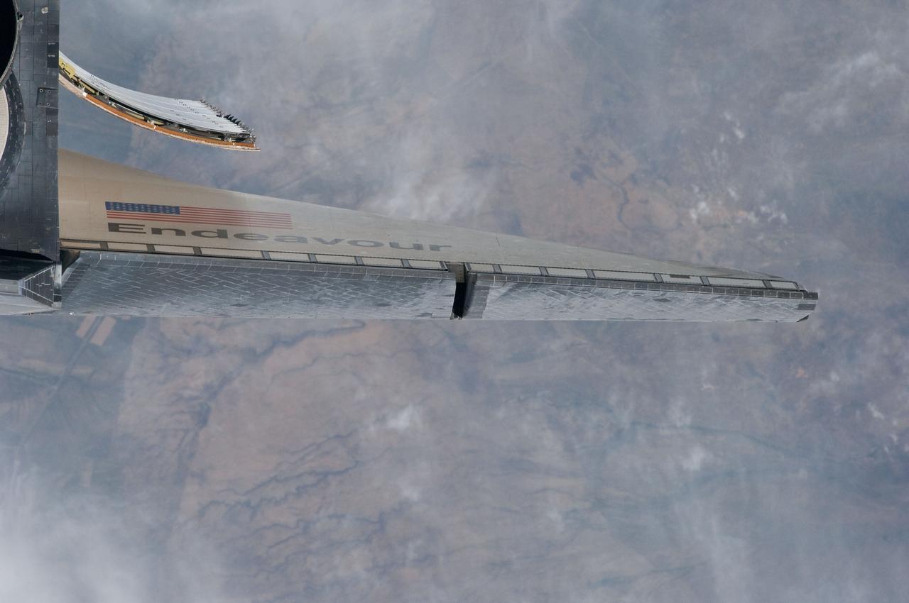 ISS027-E-032522 (18 May 2011) --- This partial view of space shuttle Endeavour’s starboard wing was provided by an Expedition 27 crew member during a survey of the approaching STS-134 vehicle prior to docking with the International Space Station. As part of the survey and part of every mission's activities, Endeavour performed a back-flip for the rendezvous pitch maneuver (RPM). The image was photographed with a digital still camera, using a 400mm lens at a distance of about 600 feet (180 meters).