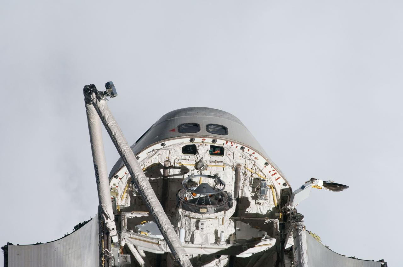 ISS027-E-032533 (18 May 2011) --- This view of space shuttle Endeavour’s forward section, including a partial view of the crew cabin, forward payload bay, docking mechanism and Canadarm, was provided by an Expedition 27 crew member during a survey of the approaching STS-134 vehicle prior to docking with the International Space Station. As part of the survey and part of every mission's activities, Endeavour performed a back-flip for the rendezvous pitch maneuver (RPM). The image was photographed with a digital still camera, using a 400mm lens at a distance of about 600 feet (180 meters).