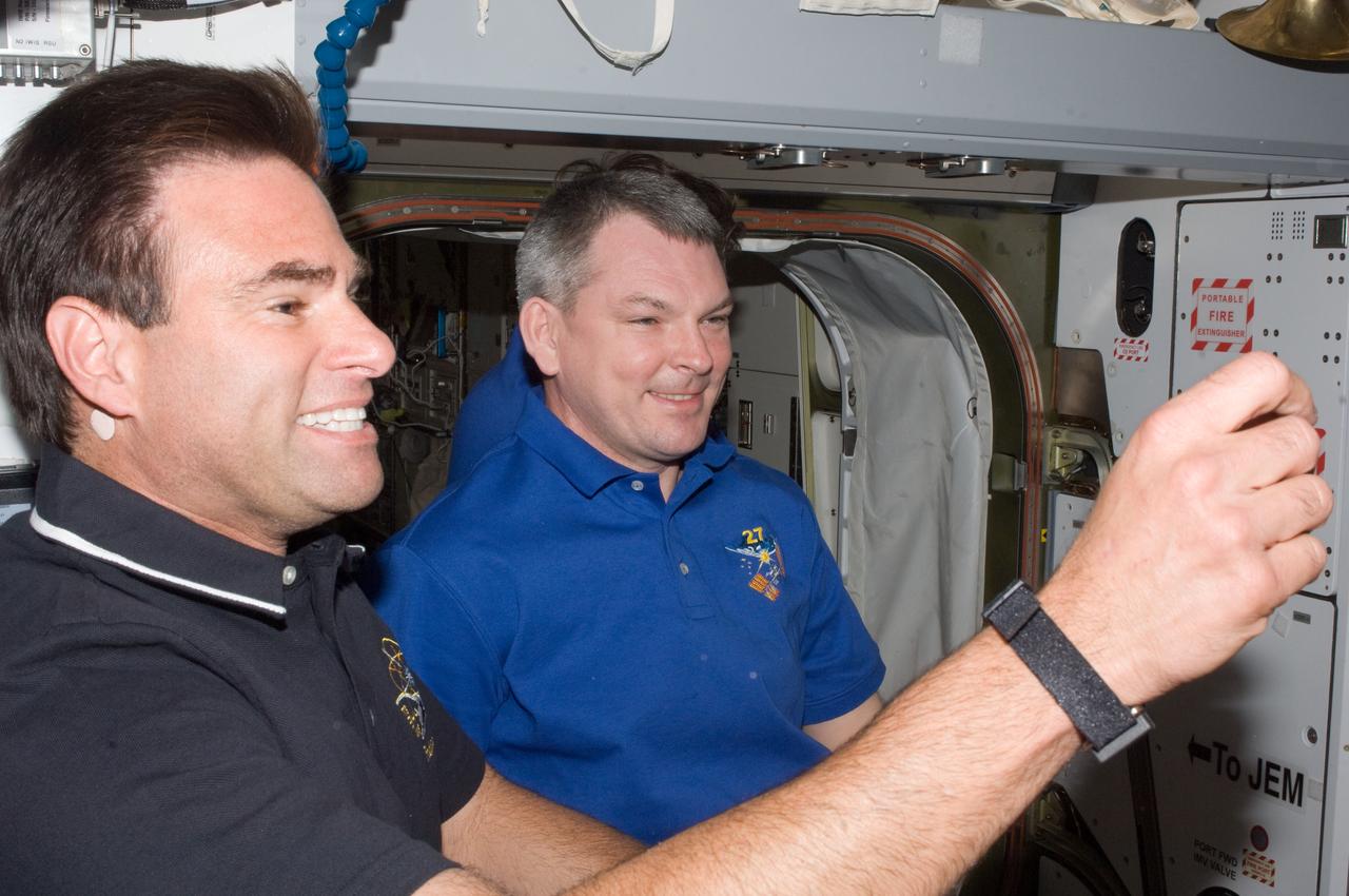 ISS027-E-032656 (18 May 2011) --- A member from each of the Expedition 27 group and Endeavour's final crew can be seen in this image recorded during a "greet and reunite" session aboard the International Space Station (ISS) on May 18, 2011. NASA astronaut Greg Chamitoff (foreground), STS-134 mission specialist, is seen with Russian cosmonaut Alexander Samokutyaev, Expedition 27/28 flight engineer.  A short while after the two spacecraft docked, the STS-134 crew members entered the ISS. Each spacecraft was occupied by six crew members until the STS-134 astronauts ingressed the ISS.