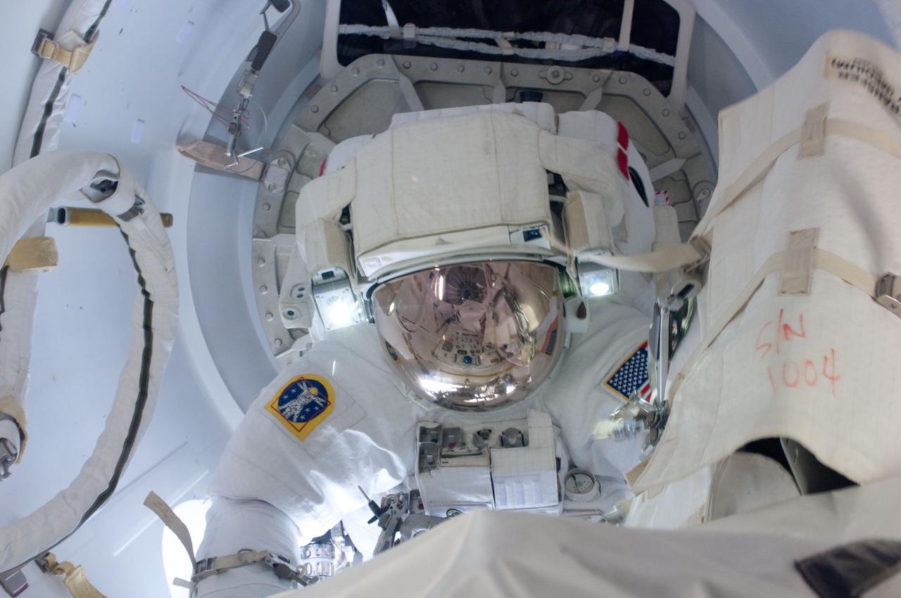 ISS027-E-034394 (20 May 2011) --- Attired in his Extravehicular Mobility Unit (EMU) spacesuit, NASA astronaut Greg Chamitoff, STS-134 mission specialist, exits the International Space Station?s Quest airlock to begin the first session of extravehicular activity (EVA) for the STS-134 mission. Astronaut Andrew Feustel (out of frame), mission specialist, joined Chamitoff on the spacewalk.