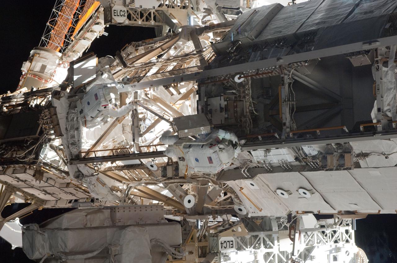 ISS027-E-034398 (20 May 2011) --- NASA astronauts Andrew Feustel (left) and Greg Chamitoff, both STS-134 mission specialists, participate in the mission's first session of extravehicular activity (EVA) as construction and maintenance continue on the International Space Station. During the six-hour, 19-minute spacewalk, Feustel and Chamitoff retrieved long-duration materials exposure experiments and installed another, installed a light on one of the station?s rail line handcarts, made preparations for adding ammonia to a cooling loop and installed an antenna for the External Wireless Communication system.