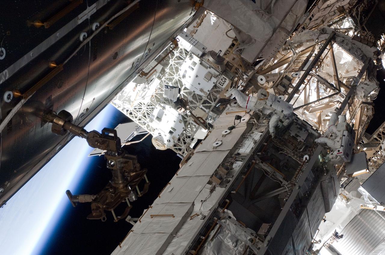 ISS027-E-034400 (20 May 2011) --- NASA astronauts Andrew Feustel (right) and Greg Chamitoff, both STS-134 mission specialists, participate in the mission's first session of extravehicular activity (EVA) as construction and maintenance continue on the International Space Station. During the six-hour, 19-minute spacewalk, Feustel and Chamitoff retrieved long-duration materials exposure experiments and installed another, installed a light on one of the station?s rail line handcarts, made preparations for adding ammonia to a cooling loop and installed an antenna for the External Wireless Communication system.
